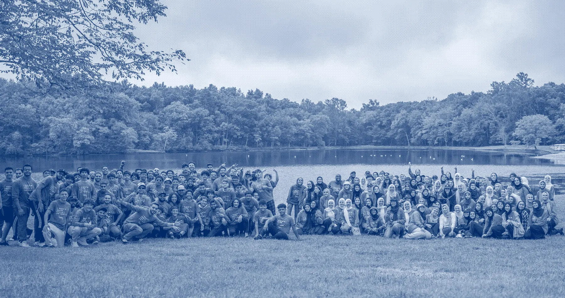 More than a hundred campers beside a lake