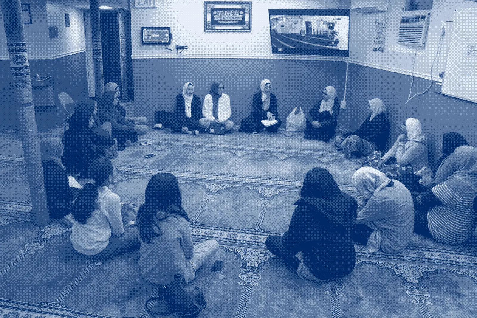 A circle of women and children in a masjid