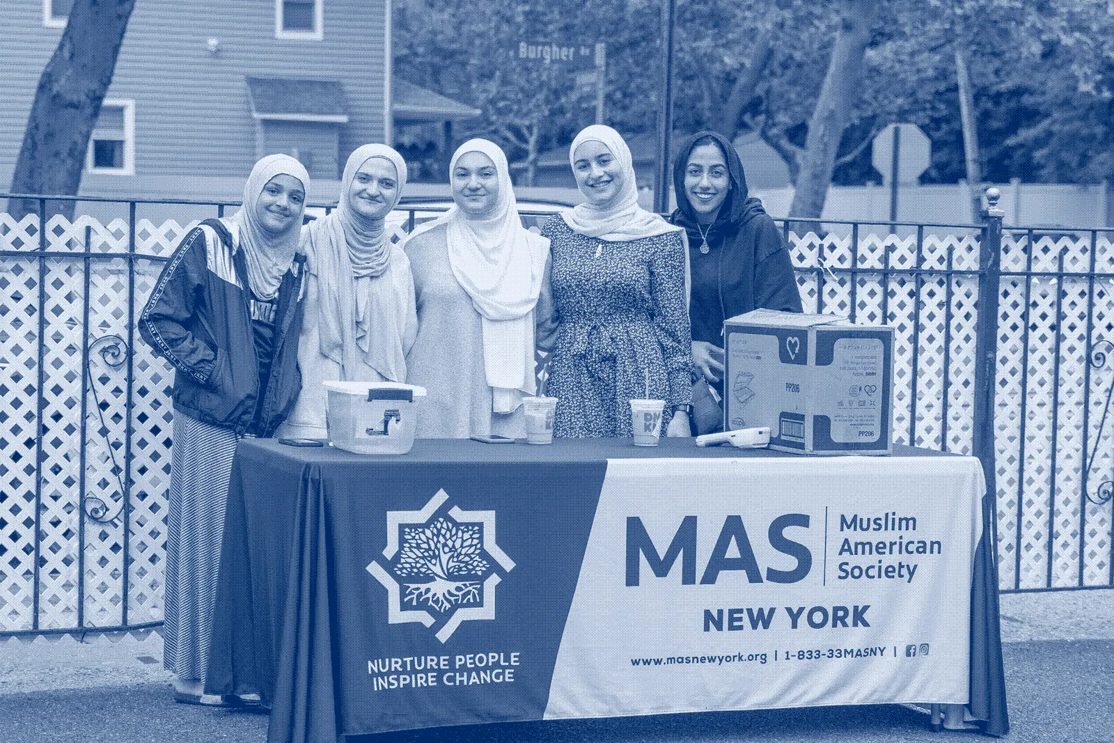 Volunteers behind a MAS New York pantry table